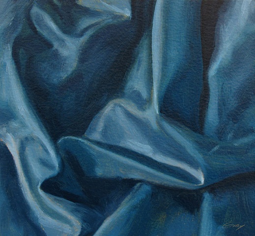 Blue satin cloth folds, close up.