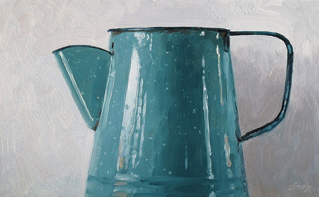 Blue enamel coffee pot on white background.