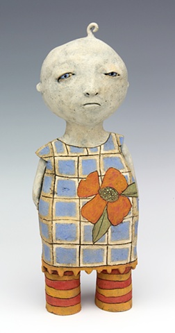 ceramic figure of a baby girl in a dress with a big flower