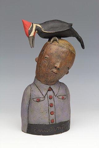 ceramic sculpture with pileated woodpecker bird by sara swink