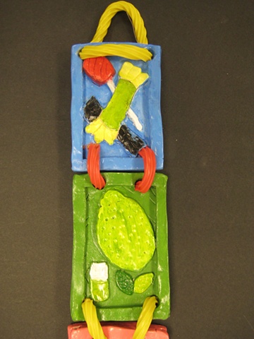 Middle School student-made clay hanging sculpture.