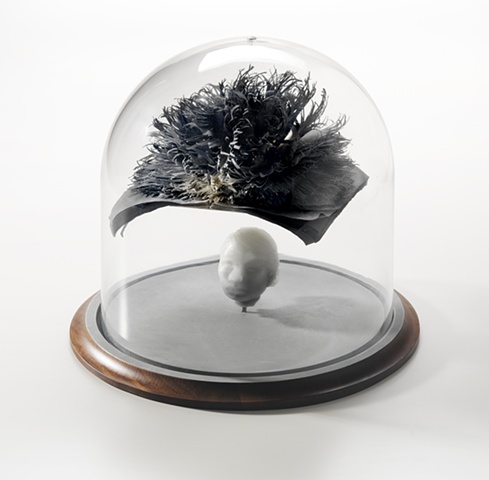cast glass head with cut paper hand dyed and bound book with hands in bell jar by leigh craven