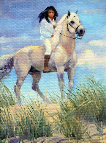 Girl on a white horse on top of sand dune.