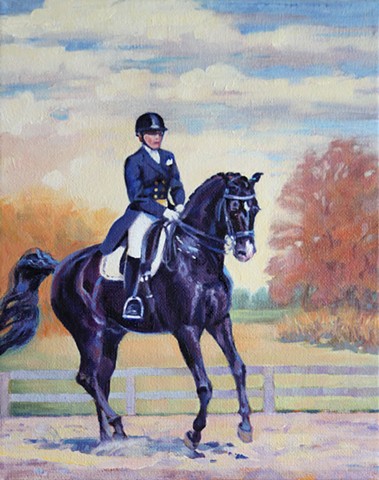 An elegantly dressed rider on a beautiful black horse going through their dressage movements. 