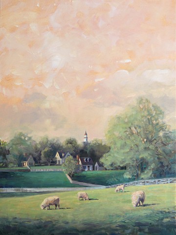 View of a sheep pasture with old Williamsburg colonial buildings in the background.