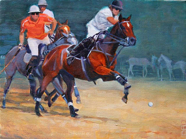 Three polo players moving the ball down the filed