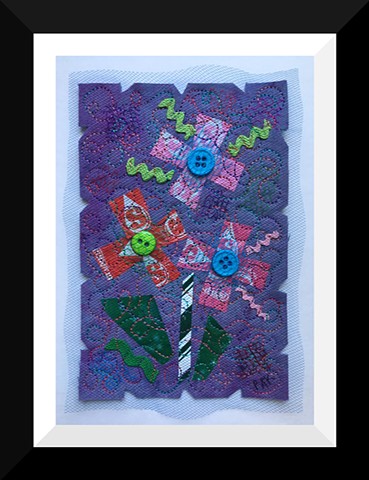 42   Purple Triplet Candy Wrapper  Flower Fiber: Framed Contemporary Art Quilt 9”x11”  Hand-dyed and commercial fabrics. Candy wrappers, buttons, found objects. Tulle, vegetable bags, netting.  Hand-dyeing, heat bonded collage, Sheer overlays ,Machine sti