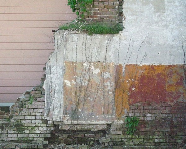 Abstract compostions of pink siding obscured by red, pink and gold deconstructed interior wall riddled with bullet holes in Clarksdale, MS, home of the blues, photograph by Baltimore artist Jo Brown copyright 2012.