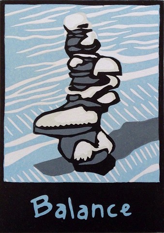 a reduction linocut of stacked stones with snow on top of the stones by Leslie Moore of PenPets