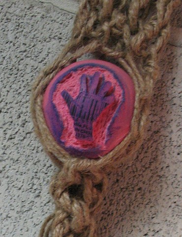 Macrame holder with carved pink ball