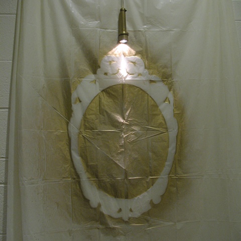 Negative image of a mirror spray-painted on the shower curtain