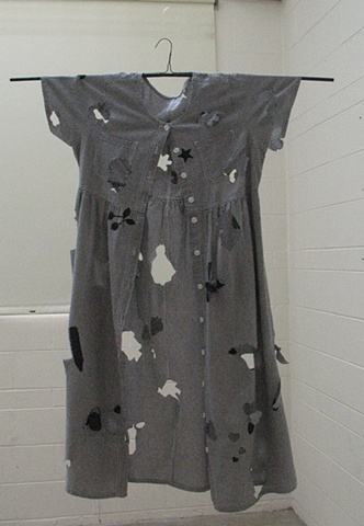 Dress with cookie cutter designs cut out of it.
