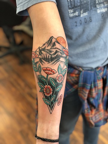 Mountainscape with flowers tattoo by Kc Carew at Gold Standard Tattoo in Bend, Oregon