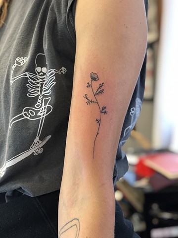 Little flower arm tattoo by Kc Carew at Gold Standard Tattoo in Bend, Oregon
