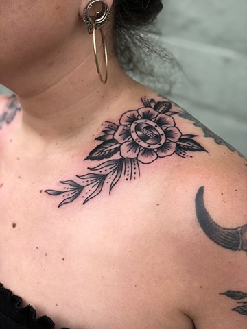 Shoulder black flower tattoo by Kc Carew at Gold Standard Tattoo in Bend, Oregon