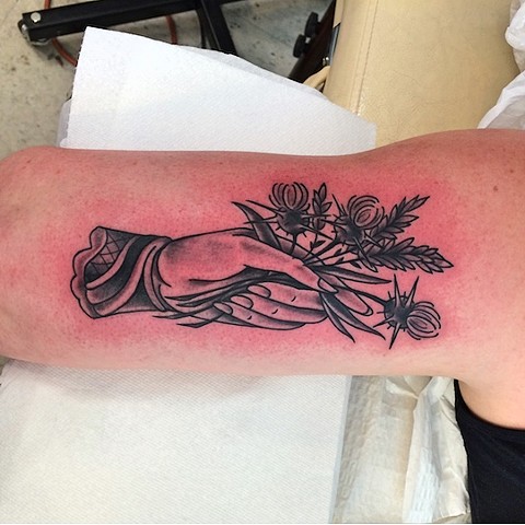Hand and flower bouquet tattoo by Dirk Spece at Gold Standard Tattoo in Bend, OR.