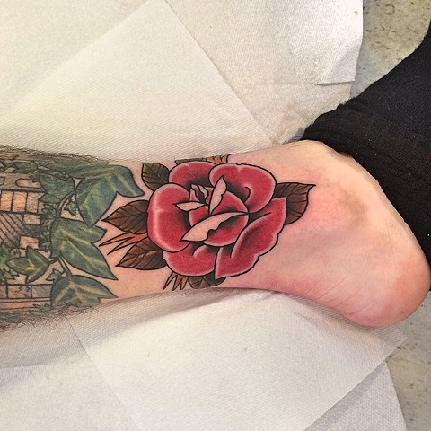 Traditional rose tattoo by Dirk Spece at Gold Standard Tattoo in Bend, OR.