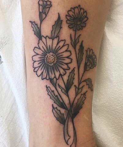 Daisy flower tattoo by Kc Carew at Gold Standard Tattoo in Bend, Oregon