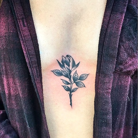 Rose on sternum tattoo