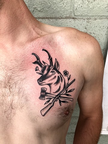 Deer gun and axe tattoo by Kc Carew at Gold Standard Tattoo in Bend, Oregon