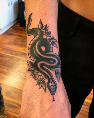 Black snake and flower tattoo by Kc Carew in Bend, Oregon