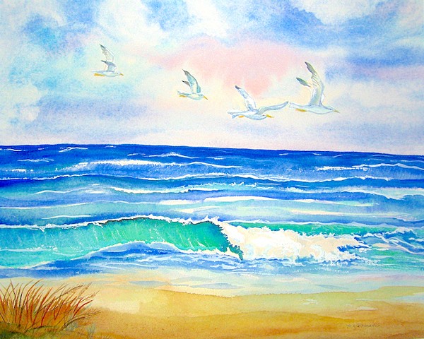 Four seagulls drift above the ocean waves on a sunny day.