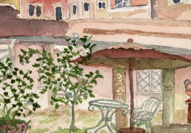 Terra cotta roof lines form the backdrop of the courtyard area of Hotel Santa Maria in Trastevere