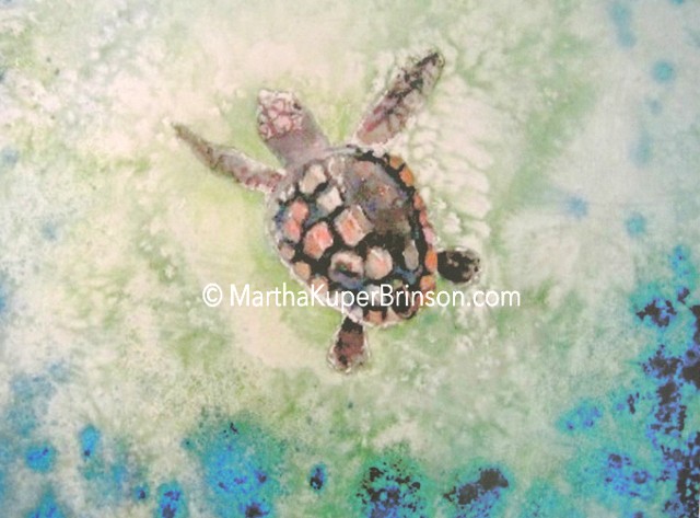 A loggerhead sea turtle makes her way through aquamarine ocean bubbles.