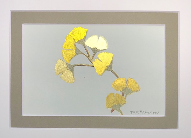 A cluster of golden ginkgo leaves against a gray backdrop.