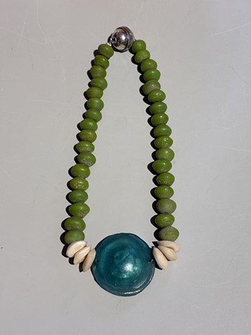 Ancient green Roman glass and white accent camel bone, paired with a recycled Javanese glass pendant
