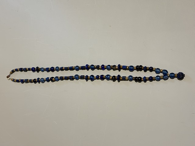 Blue lapis glass and bronze spacer beads with a lapis charm (25015)