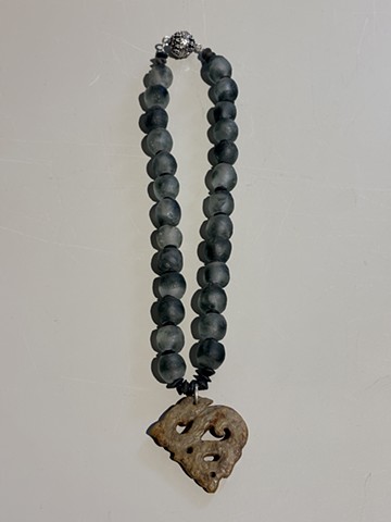 Smoky slate glass beads with serpentine spacers and an ancient Tibetan carved jade pendant