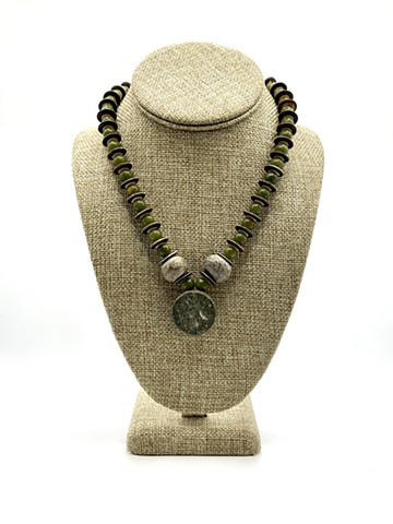 Matte green jade, yak bone, Pleistocene (aka the Ice Age) fossilized dinosaur bone / Serpentine Sassanian Zoroastrian 'Winged Being' pendant (250-500 AD) with a Moroccan sterling silver clasp