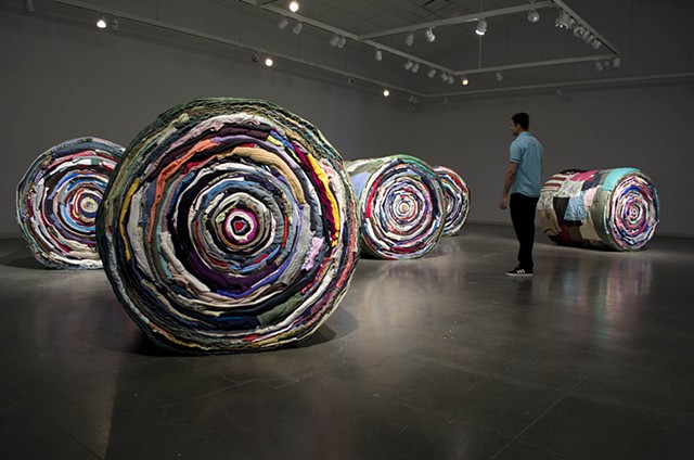 Art installation of full scale round bales made out of used clothing and bale netting