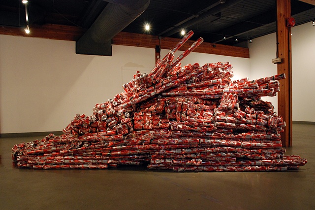 Sculpture of mountain made out of reclaimed coke cans and packing tape
