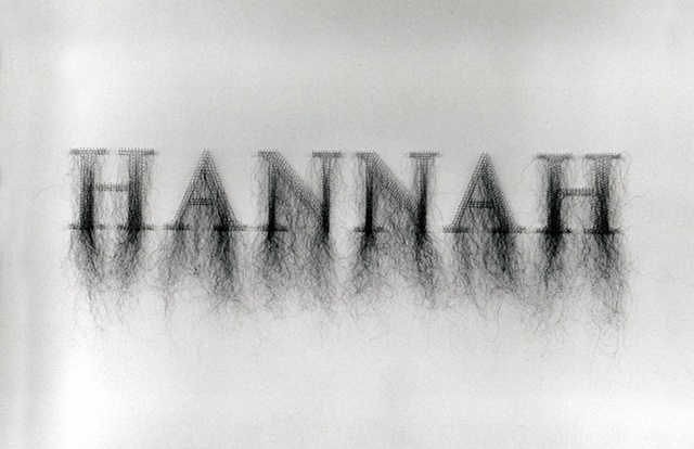 Art installaiton of names made with human hair and straight pins