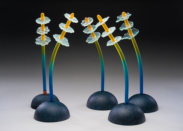 borosilicate glass stems with float glass flowers and cast concrete bases