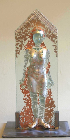 kiln-cast glass female figure supported by steel frame, with silver and copper