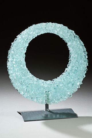 recycled glass re-melted into a new shape, with a welded steel stand
