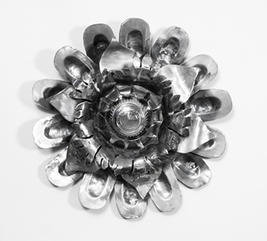 Steel sculpture with Baroque flourishes and hub cap
