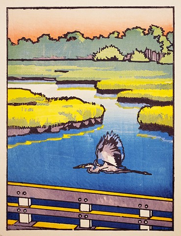 A woodblock print by Dan Fionte of a Great Blue Heron flying low over a marshy river, alongside a bridge upon which the viewer is also travelling.