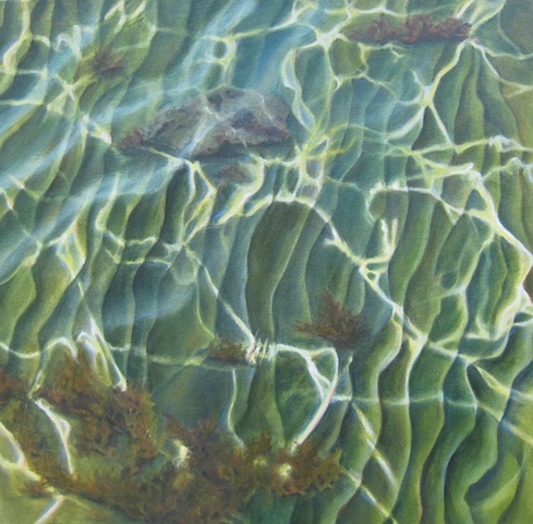 Light patterns play over water's surface to sculpted sandy bottom.