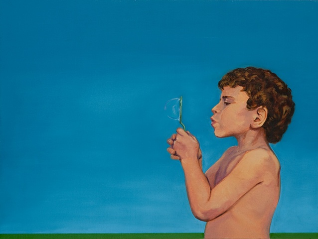 small boy facing left and blowing a bubble