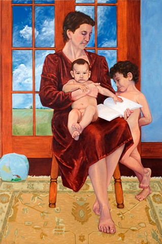 Seated woman with baby on lap holding a book while young boy stands to right