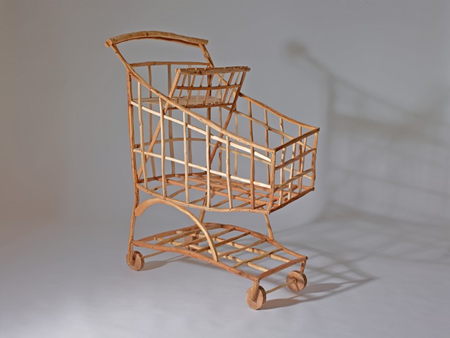 Wood sculpture about shopping carts by Lin Lisberger