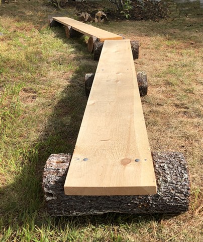 Sculpture about a bog bridge and fire pit wood bundles at Baxter State Park by Lin Lisberger