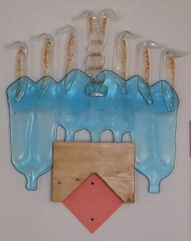 Bottle glass, red frit, wood.  A wall piece.