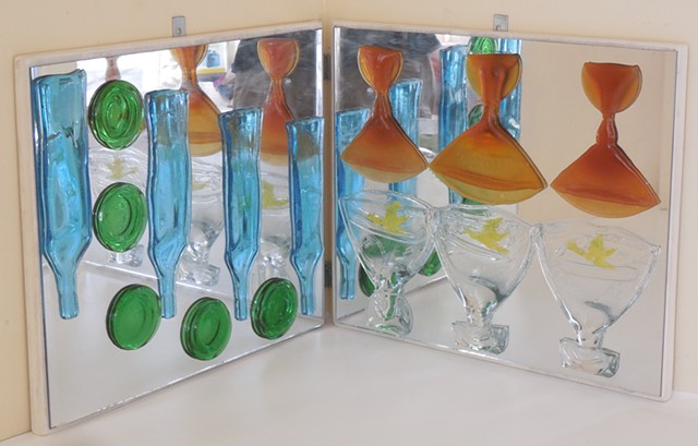 Mirrors at a right angle.   Slumped bottle parts and glasses.   For a corner or pedestal.