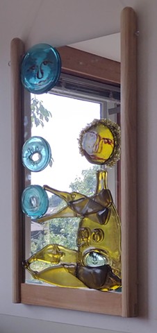 recycled mirror, slumped and fused bottle glass, red frit, yellow swarf, wood frame.