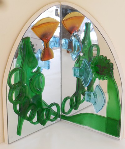 Mirrors at a right angle.   Slumped and fused bottle parts and glasses.   For a corner or pedestal.